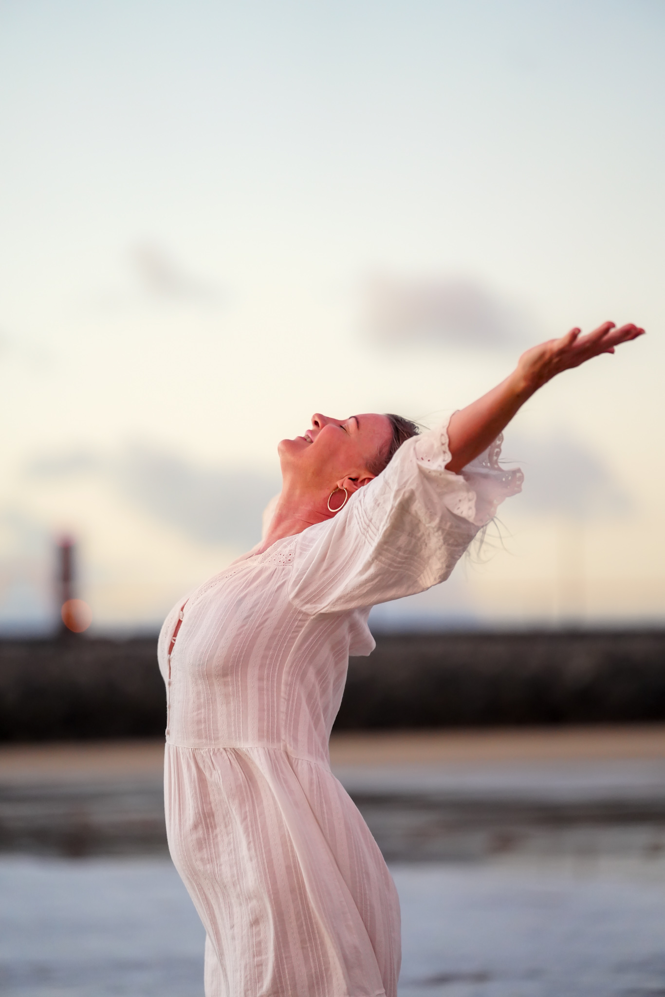 Susan Deakin | Sovereign Woman Podcast Host & Founder of Unity Yoga Ayurveda Susan Deakin standing on the beach at sunrise in Mackay Queensland, embodying freedom, self-trust and authentic living as host of the Sovereign Woman Podcast and founder of Unity Yoga Ayurveda.